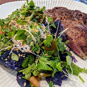 Grass fed ribeye steak with a purple potato