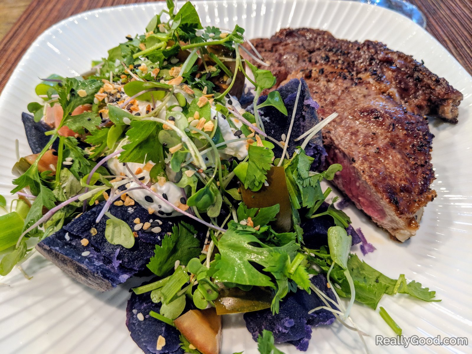 Grass fed ribeye steak with a purple potato