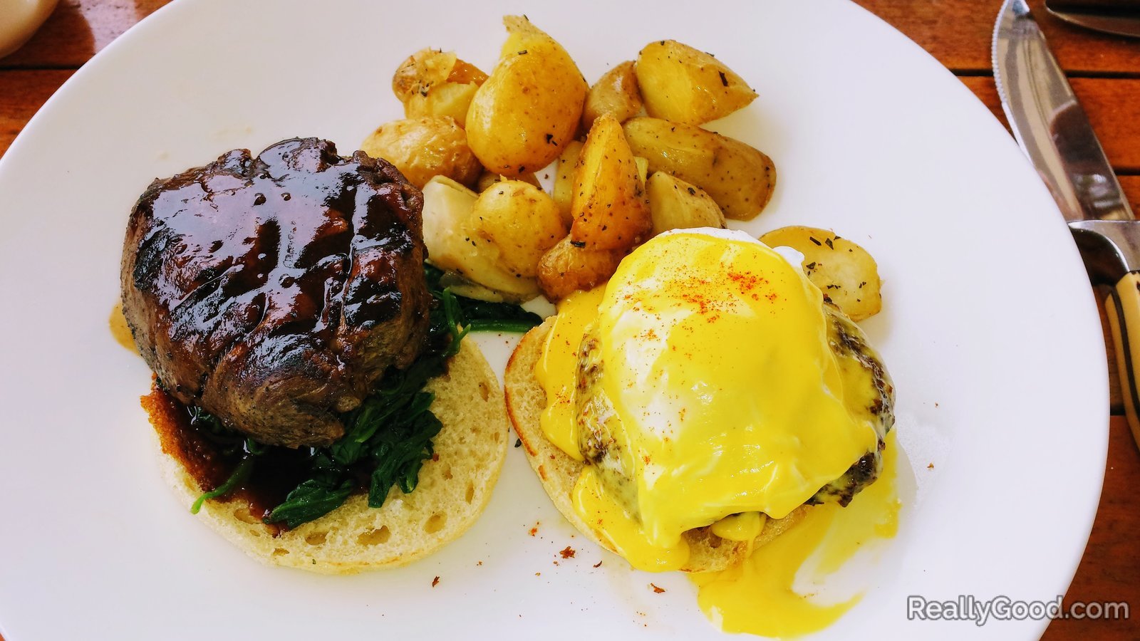 Steak and eggs benedict with potatoes
