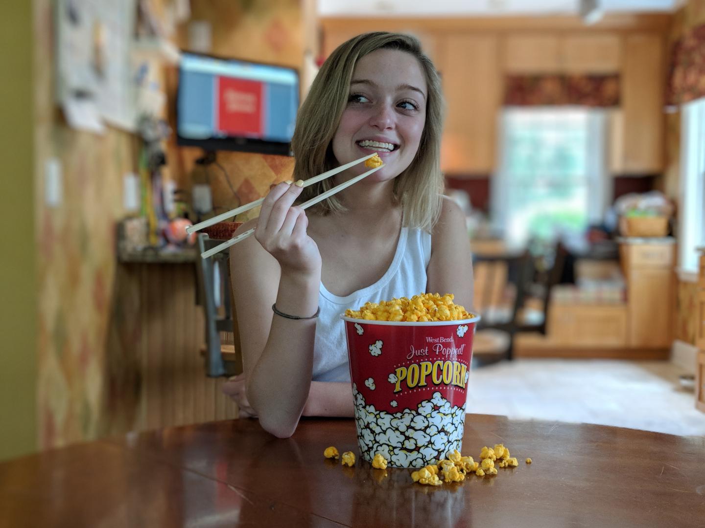 Eating popcorn with chopsticks